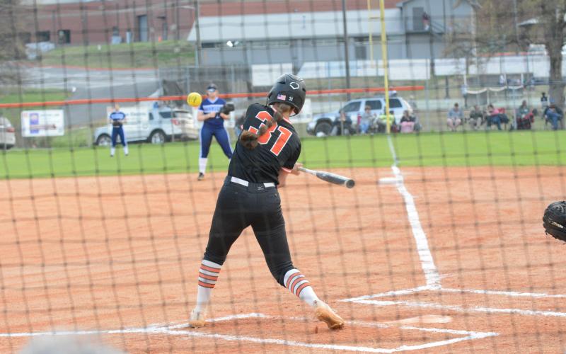 Emma Faust swings for the fences in a slow-pitch softball game versus Elbert County during the 2023 season.