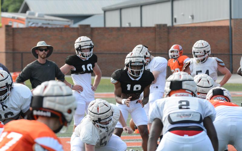 Jashon Gaines awaits the snap as the two rising seniors battle it out for the quarterback position in spring practice.