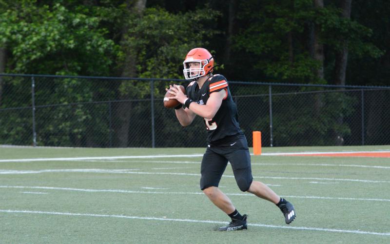 Pictured is rising senior quarterback Kip Phillips as he sets to deliver a 70-yard touchdown pass to Trey Martin.