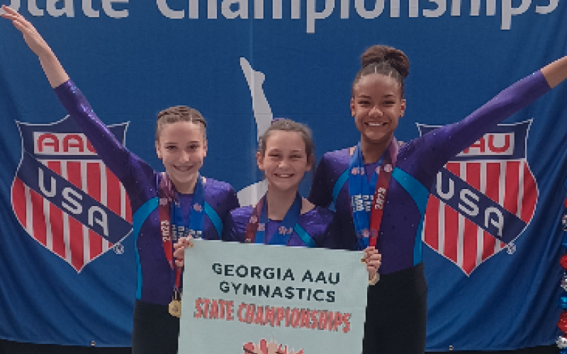 Pictured from left to right Madalyn Dault, Maci Dudley, Cheyenne Rucker who are the XCEL Diamond state champions.