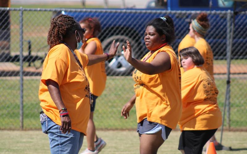 Pictured at the bottom is Barbara Harper, Makerria Roebuck and Jessica Mercer giving each other a high five after an event.