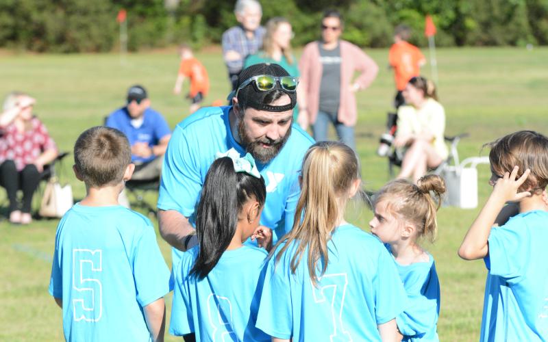 Tim Allgood coaches up his team before a game for the YMCA soccer league.