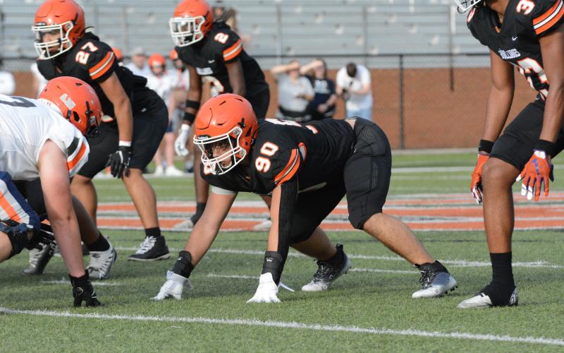 Rising senior defensive end Harley Harris (90) gets set in his stance and awaits the snap in the 2023 spring game versus Habersham Central on Friday, May 19.