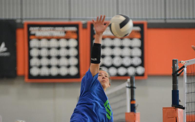 Senior outside hitter Lillie Kate Rogers spikes the ball.