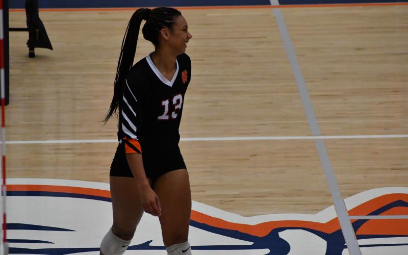 Senior middle hitter Alexis Walker smiles after winning a set as the Volley Dogs sweep Habersham Central in three sets to start the year 1-0.