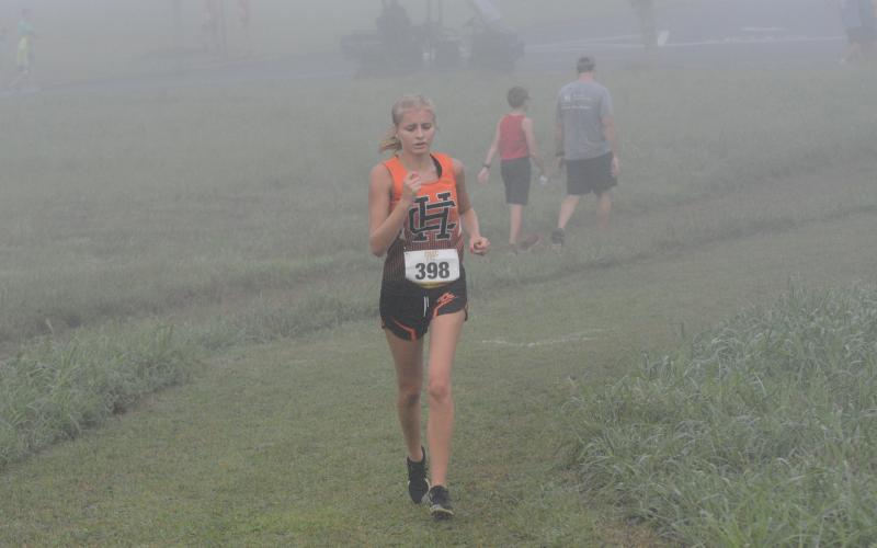 Senior Chloe Bennett fights through her injury to finish the race at East Jackson Aug. 12.