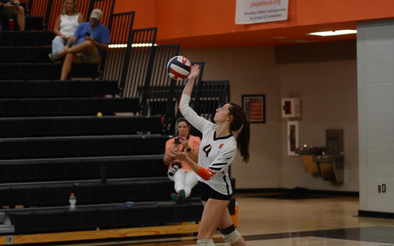 Senior Ryann Williamson serves during their two-set win over Monsignor Donovan Aug. 17.