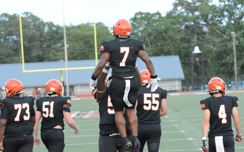 Senior running back Nori Moore (7) celebrates with his teammate after scoring a touchdown in the 2023 spring game versus Habersham Central on Friday, May 19 in Herndon Stadium.