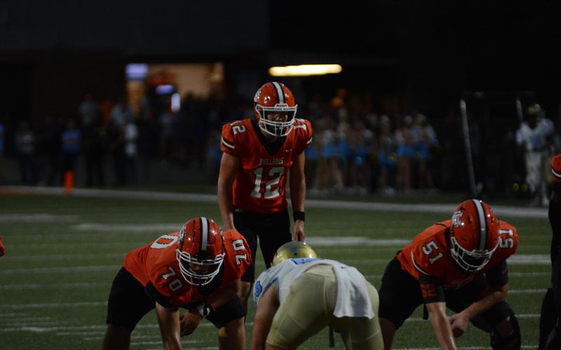 Senior quarterback Kip Phillips (12) awaits the snap in the loss to Daniel Sept. 8, 52-21.