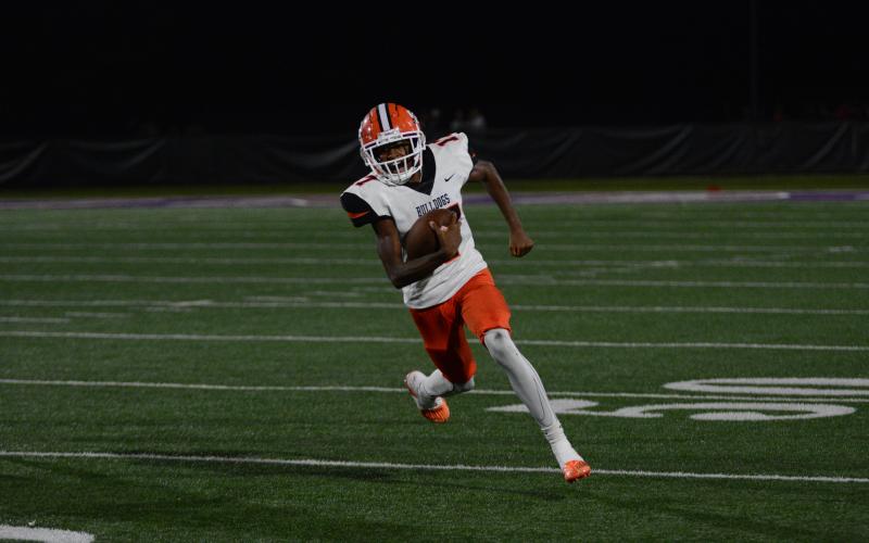 Freshman quarter back Kurston Curry keeps the football and attempts to pick up the first down in the road loss to the Indians of Lumpkin County, 30-10 in Dahlonega Sept. 15.