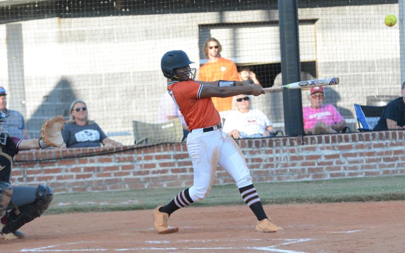 Senior infielder Jazz Shealer hits a hard hit ball into the outfield in the 8-4 home loss to the Lady Lions of Hebron Christian.