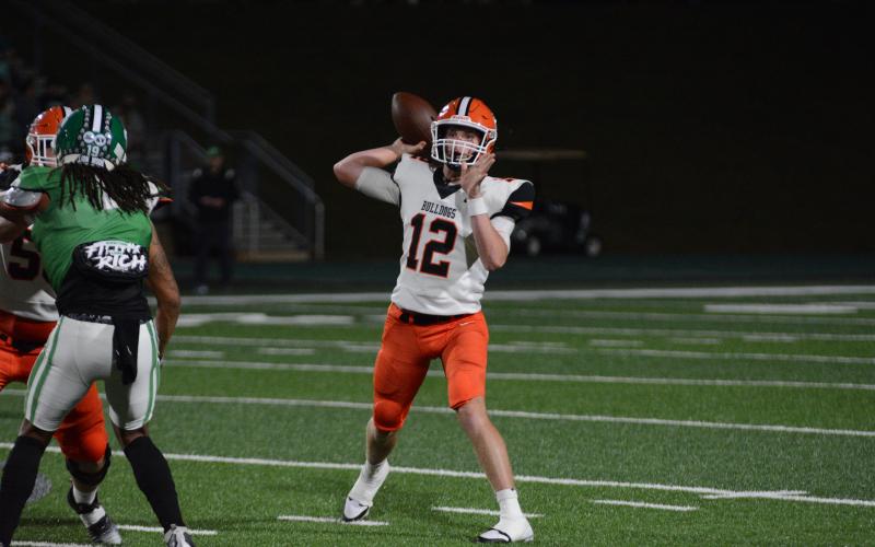 Senior quarterback Kip Phillips (12) completing a pass to senior receiver Jashon Gaines (not pictured) in the 40-14 road win over Franklin County to capture the first region win of the season for the Dogs.