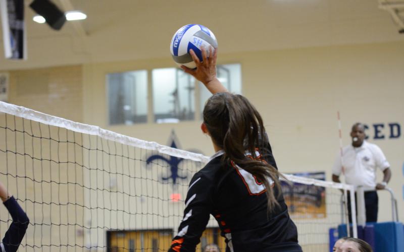 Senior Lillie Kate Rogers pushes the ball over the net for a point.
