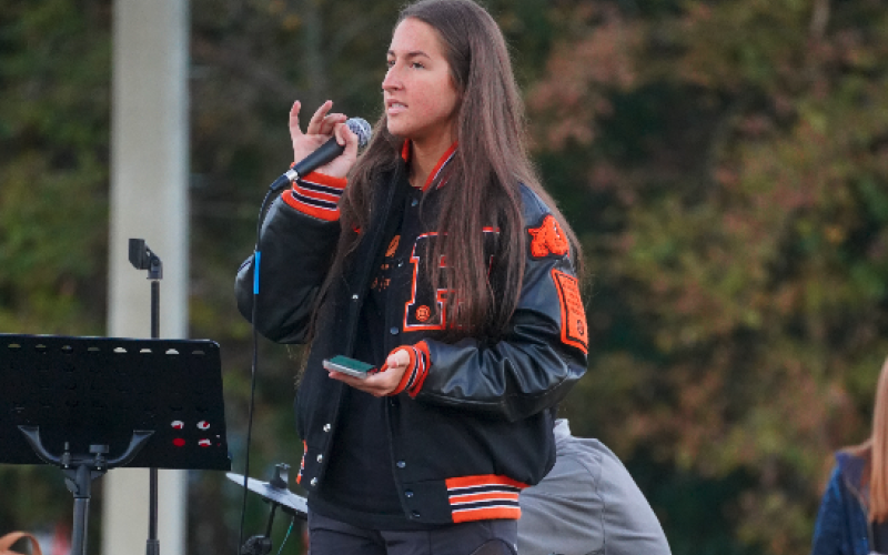 Pictured is then junior, now senior, volleyball player Lillie Kate Rogers as she shares her testimony during the 2022 Fields of Faith event at Veterans Stadium at HCMS.