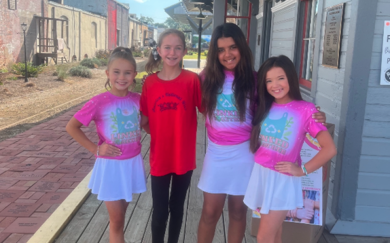 During their fall break from school, students (from left to right ) Haley, Andi Jane, Lila, and Sophie volunteer with Linked Together making mats for the homeless.