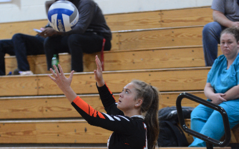 Senior Dakota Phillips serves a ball into play.