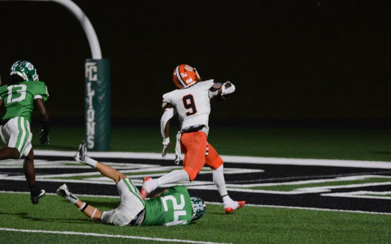 Junior linebacker Timothy Newton (9) breaking away from the Lion’s defense to score a rushing touchdown from 26-yards out, as he took reps at running back.