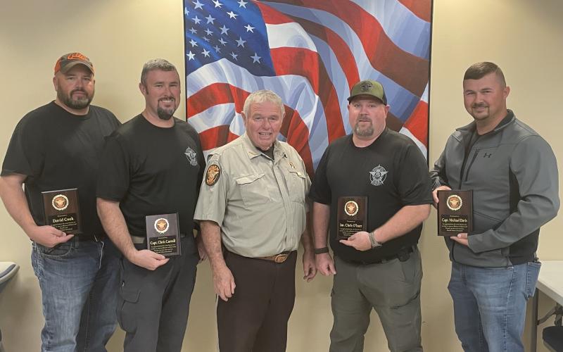 From left to right: Former sheriff’s deputy David Cook, Captain Chris Carroll, Sheriff Mike Cleveland,  Sergeant Chris O’Barr, and Captain Michael Davis.