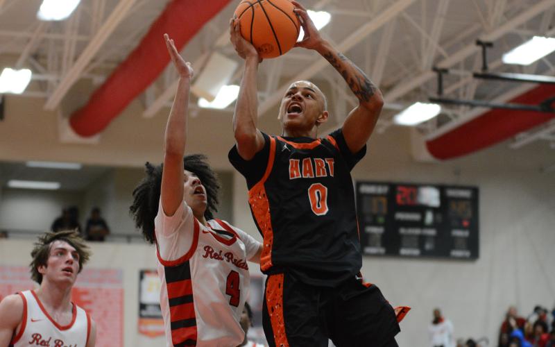 Junior guard Keelan Stowers goes up for the contested shot in the 86-56 loss to Madison County on Nov. 28.
