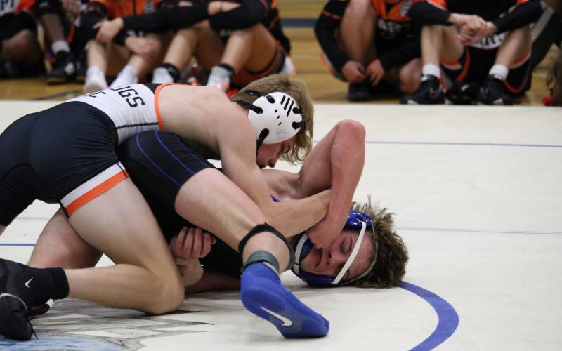 Junior Harrison Krause pins an Oconee County Warrior during a 2022-2023 match.