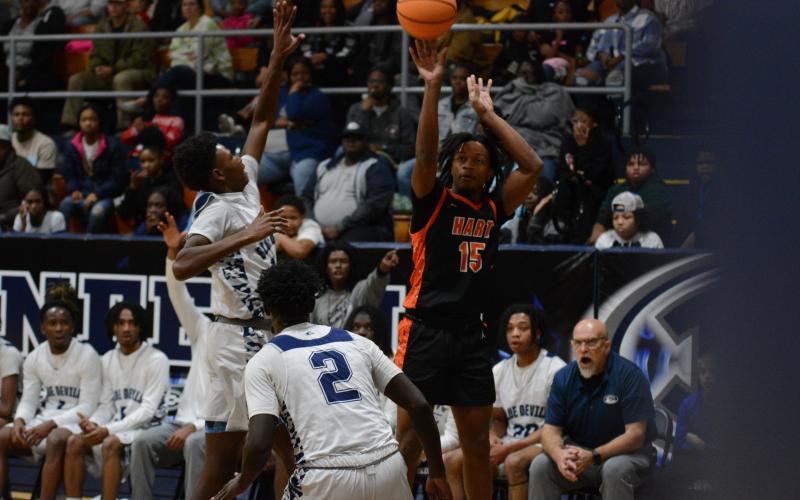 Junior forward Chaiden Harland knocks down a three in the 65-61 loss against the Blue Devils of Elbert County Dec. 15.