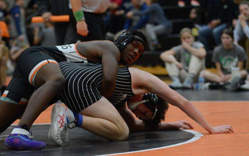 Freshman Champ Blackwell attempts to pin his opponent back on Jan. 16 during their home meet against Dixie.