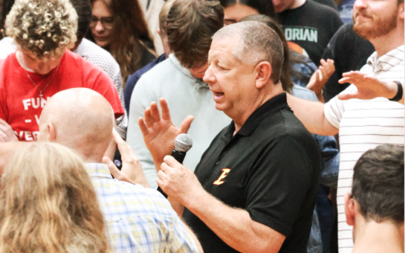 Emmanuel University President  Greg Hearn prays with his students.