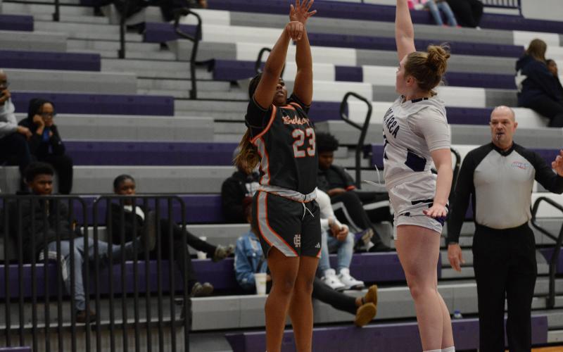 Junior guard TK Smith drills a three pointer over a Lady Hurricane, as she scored nine points, and led the team with seven rebounds and two assists in the 62-20 win over the Lady Hurricanes of Monroe Area on Jan. 10.