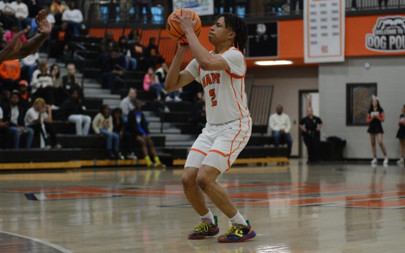 Junior guard O’Brian Evans knocks down a long range three in the 80-45 win over Carver (Atlanta) on Feb. 21.