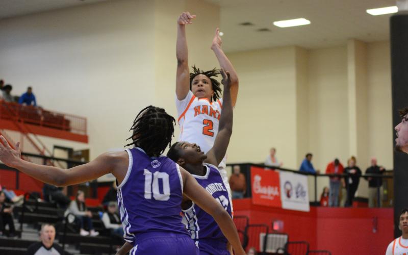 Pictured is junior guard O’Brian Evans (2) shooting over a Purple Hurricane defender.
