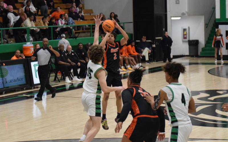 Junior guard O’Brian Evans knocks down a three to help give Hart County the late lead in the 61-55 road win over the Lions of Franklin County on Feb. 9 to secure the No. 2 seed heading into the region tournament. Photo by Shane Scoggins/Franklin County Citizen Leader