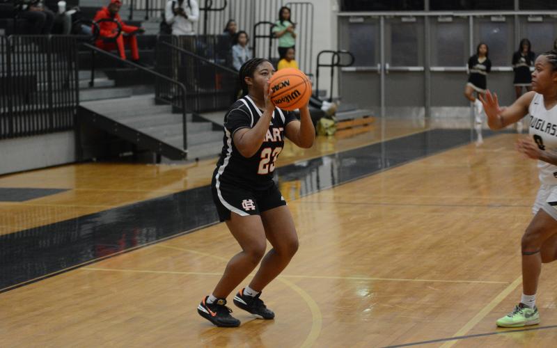 Junior guard TK Smith knocks down seven threes in the 64-44 win over Frederick Douglass High School on Feb. 20.