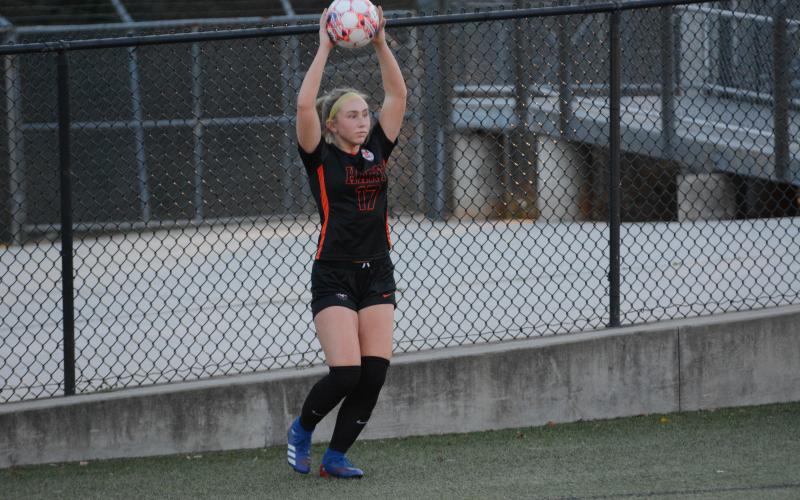 Junior midfielder Teague Pierce looks to throw the ball into play during the 4-1 win against Commerce March 8.
