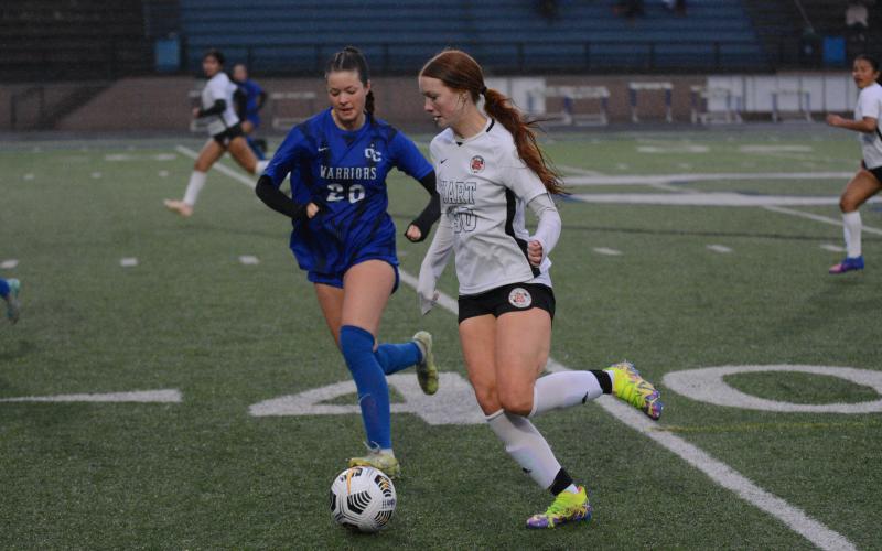 Junior forward Channing Segars dribbles the ball up the sideline in the 8-0 loss to the Lady Warriors of Oconee County.