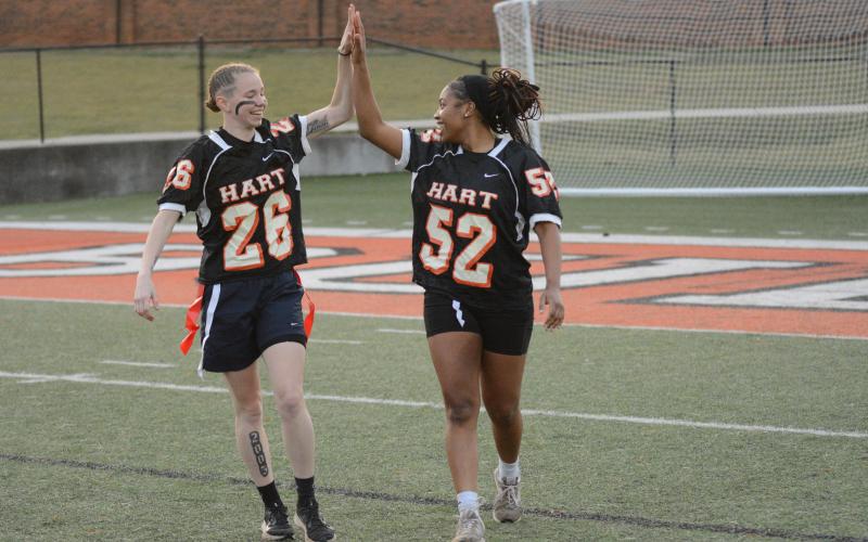 Madison McLane (left) and Jazz Shealer (right) high five as they both had interceptions.