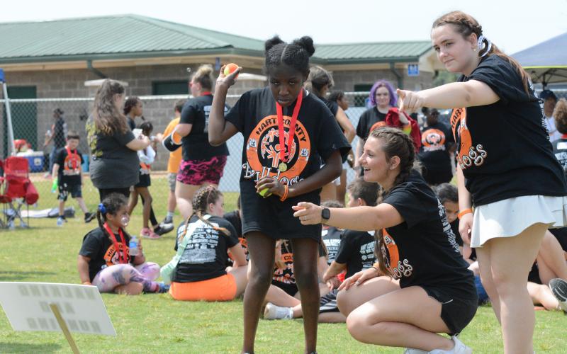 Pictured from left is sophomore Special Olympic athlete Abigal Kent alongside senior Sage Robach and junior Katie Sanders at the ball throw at the Special Olympics April 17.