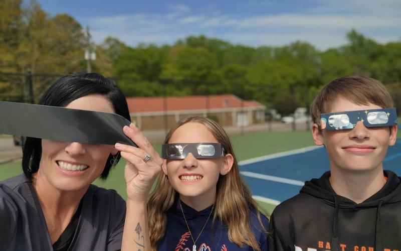Pictured from left is Susan Carroll, her daughter Tora Carroll, and her son Jayce Carroll as Susan works in the Radiology Department at St. Mary’s Hospital in Athens and decided to improvise by using x-ray film as well as trading off glasses with her kids.