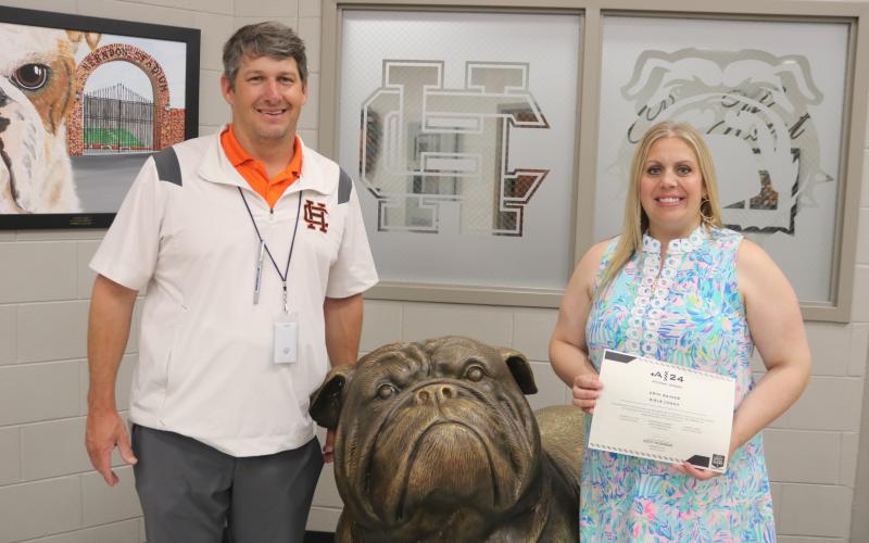 Hart County High School’s athletic director Cory Dickerson (left) presents HCHS girls tennis coach Erin Gaines (right) with the Most Positive Girls Coach Award on May 10.
