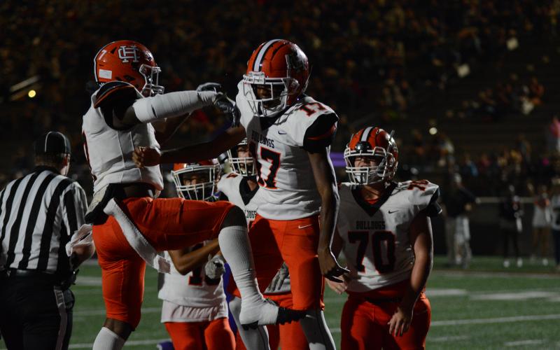 Rising sophomore quarterback Kurston Curry celebrates with teammates after rushing in the endzone for a touchdown against Lumpkin County in the 2023 season, as he will take over under center for the Bulldogs this upcoming season.