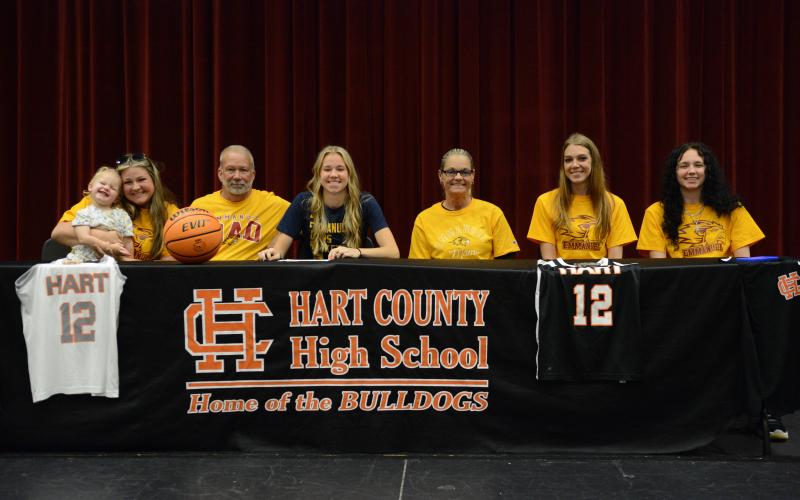 Madison McLane (middle) signs with Emmanuel to compete in track and basketball.