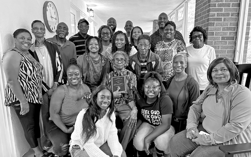 The Senior Center’s longest-attending member, Idell Morrison (center), surrounded by her family and holding the plaque that will hang in the new porch in her honor.
