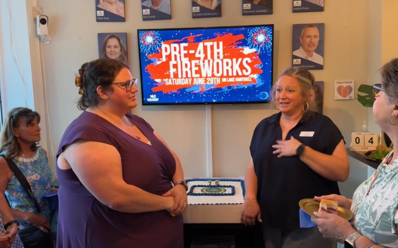 Rachel Black /The Hartwell Sun Hart Chamber of Commerce Executive Director Lindsey Ingle (right) and Assistant Director Amanda Brown speak to community members during the Chamber’s 75 anniversary ceremony June 4.