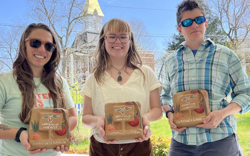 Hartwell’s Jennie Bosman, center, donated four pavers she designed and created to the Vickery House garden, poses with Morgan Southerland, Hometown Harvest coordinator, left, and Kelly West, director of UNG’s Appalachian Studies Center.