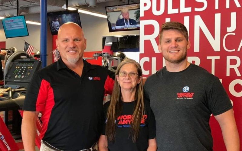 From left to right: Bill, Sheri, and Bret Cesak at one of Workout Anytime’s locations.
