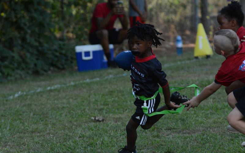Pictured is Lynx Brewer as he avoids the defender on his way to score a touchdown.