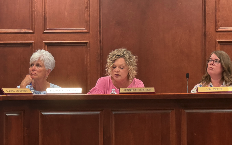 From left to right: Board member Henley Cleary, Superintendent Jennifer Carter, and Board Chair Kim Pierce review amended policy recommendations .