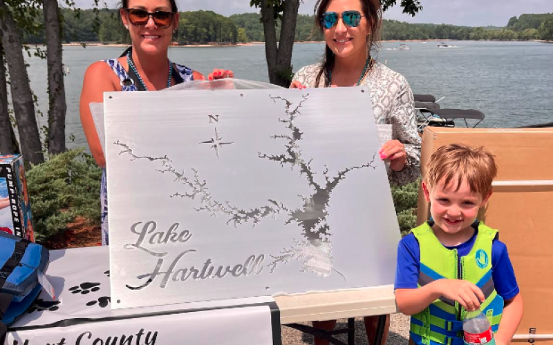 Joanie Haley (left) was declared the winner of the pontoon poker run. She won with a full house, and chose to take the metal map of Lake Hartwell. She posed for the picture with Laura Dickerson and her son Jordan Haley.