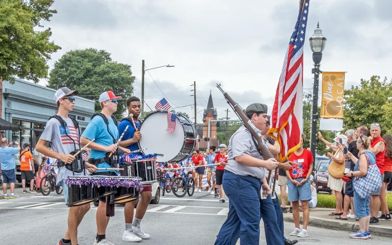 Color guard and drum sections lead off the children’s parade.