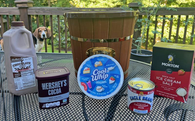 Sparky, the family’s Treeing Walker hound, spies the fixings for Tallulah chocolate on the NeSmiths’ backyard deck in Habersham County.