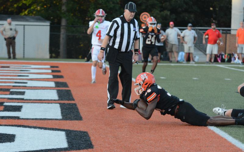 Sophomore running back Faustino Rangel dives in the end zone to give the Dogs an early 6-0 lead in the overtime loss to Madison County, 37-36 at home on Aug. 23.